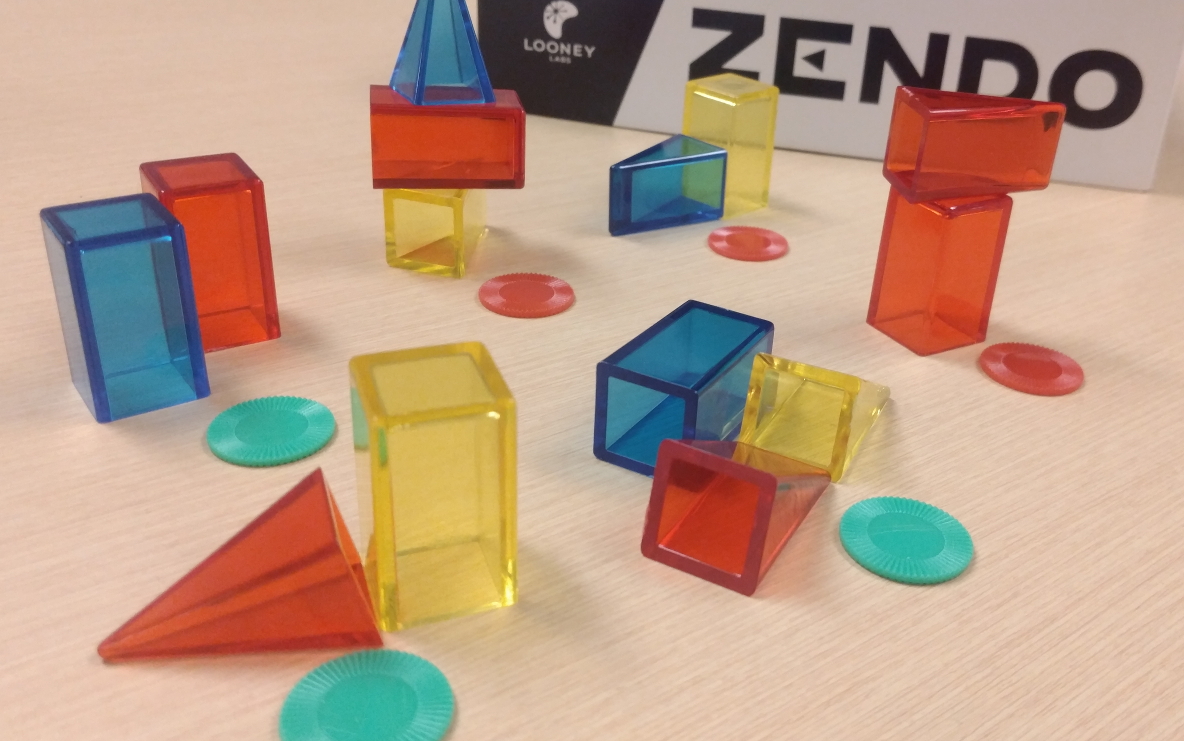 Seven sets of coloured blocks, some marked with a green token and some with red.